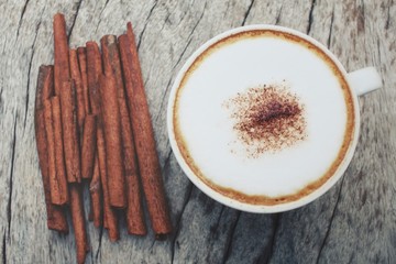 Cappuccino coffee with cinnamon sticks