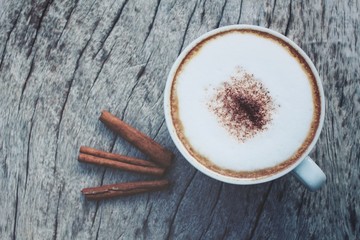 Cappuccino coffee with cinnamon sticks