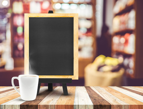 Blackboard menu with easel on wooden table with coffee cup at bl