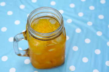 Ice orange juice in the glass jar
