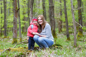 Mother and child outdoors playing, kissing and hugging