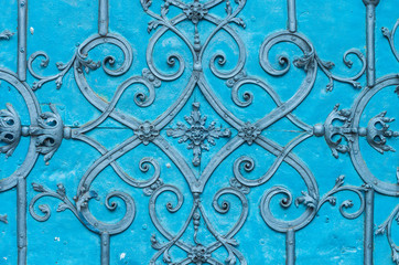 Close up of blue painted richly decorated baroque steel door