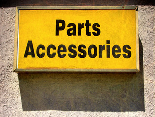 aged and worn vintage photo of parts accessories sign