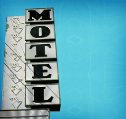 Obraz premium aged and worn vintage photo of retro motel sign with room for text