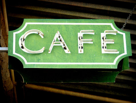 Aged And Worn Vintage Photo Of Neon Cafe Sign