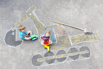 Two little kid boys with excavator chalk picture
