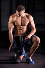 Fototapeta na wymiar Cool young bodybuilder in gym
