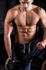 Fototapeta na wymiar Tough young bodybuilder in gym