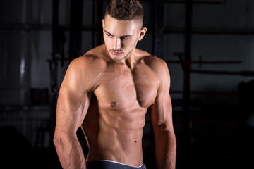 Fototapeta na wymiar Handsome muscular young man in gym
