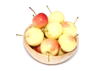 Apples in wooden cup.