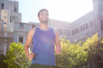 Smiling handsome athlete jogging