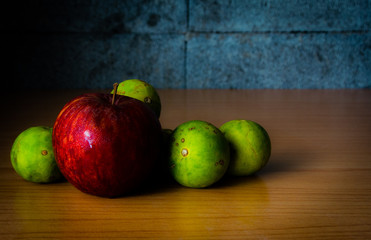 Red Apple, Lime and Coffee bean on a wood with Selective focus, Vintage tone.