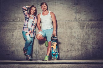 Young couple with skateboard  outdoors