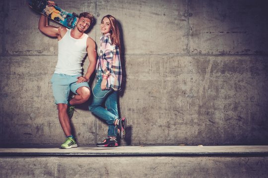 Young couple with skateboard  outdoors