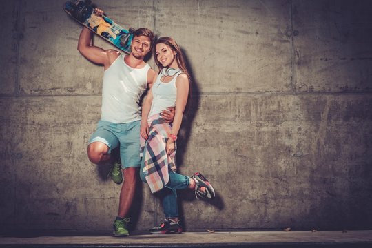 Young couple with skateboard  outdoors