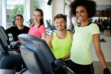Fototapeta na wymiar People on a elliptical training machine in a gym