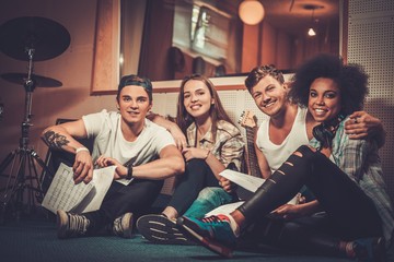 Multiracial music band performing in a recording studio