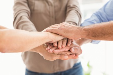 Business colleagues stacking hands together