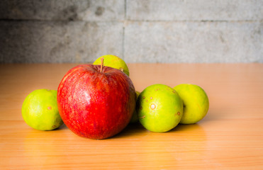 Red Apple, Lime and Coffee bean on a wood with Selective focus, Vintage tone.