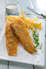 Fish and chips. Fried fish fillet with french fries wrapped by p