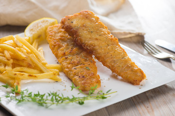 Fish and chips. Fried fish fillet with french fries wrapped by p