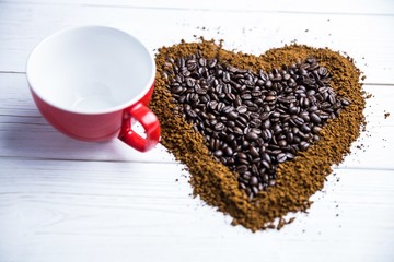 Coffee on a table in heart shape with cup