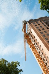 Crane and building construction site against blue sky, established in Lenina  avenue in Rostov - on - Don.