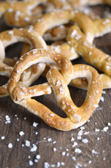 Pile of Salty Baked Bavarian Pretzels on Dark Wood