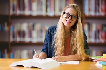 Composite image of student studying in the library 