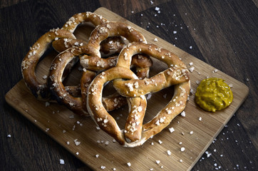 Salt Pretzels and Mustard on Rustic Dark Wooden Table
