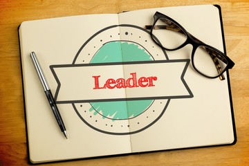 Leader against overhead of open notebook with pen and glasses