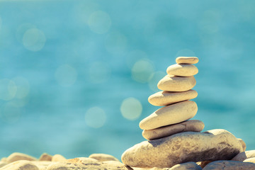 Stones balance at the beach, stack over blue sea