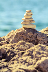 Fototapeta na wymiar Stones balance at the beach, stack over blue sea