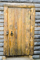 Loghouse wooden door with a padlock