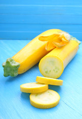 yellow zucchini (squash) on a blue background