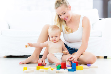 Mother and baby playing with blocks