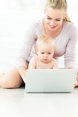 Mother and baby using laptop