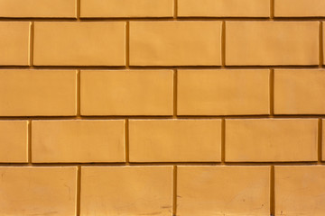 Obraz premium Background with fragment of yellow brick wall