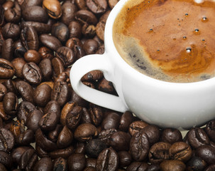 White cup on coffee beans background
