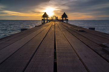 Wooded bridge in the port and sunset