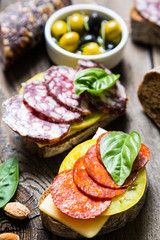 Sandwiches with salami, basil and olives