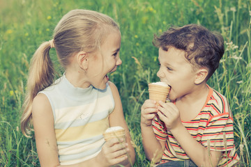 Fototapeta premium Three happy children playing in park