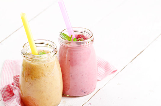 Carrot banana and raspberry shake on wooden table