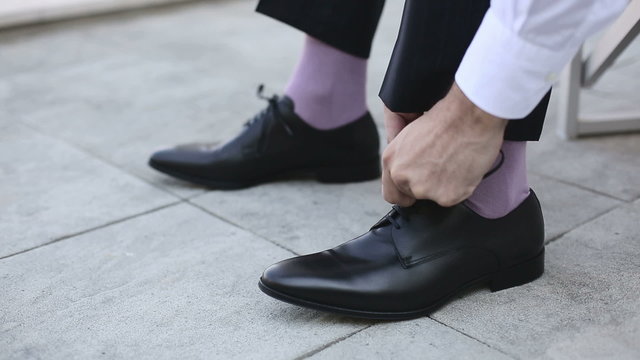 Businessman lace up black shoes