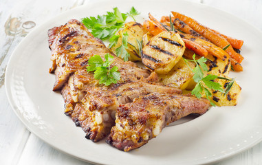 Grilled Pork Ribs and Fried Potatoes on White Plate