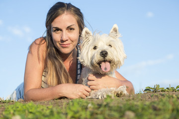 portrait of beautiful girl keeping pretty white West Highland