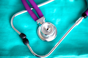 A stethoscope shaping a heart and a clipboard on a medical