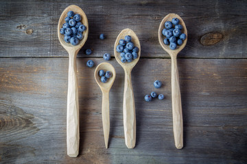 Blueberries on a wooden spoons