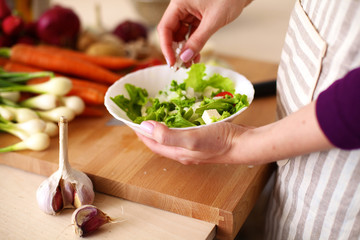 Young Woman Cooking in the kitchen. Healthy Food