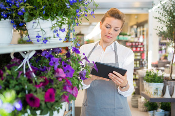 Woman Using Digital Tablet In Flower Shop